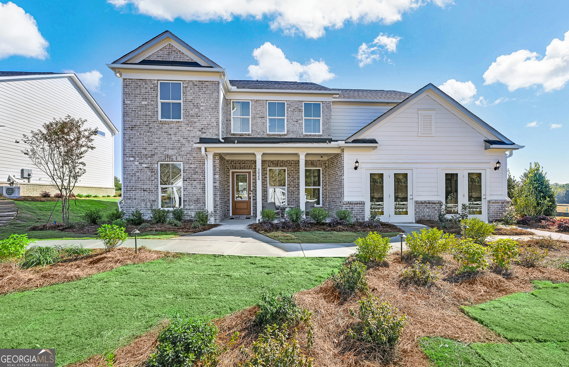 a front view of a house with yard and green space