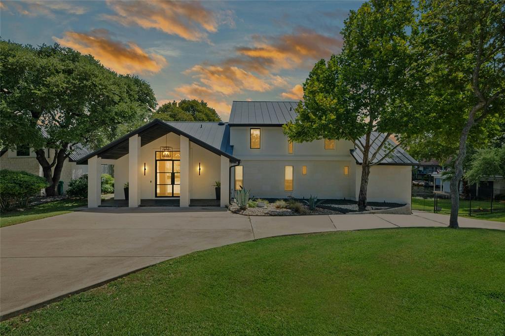 a view of a house with a yard and tree s