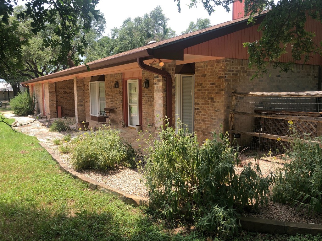 a backyard of a house with garden and patio