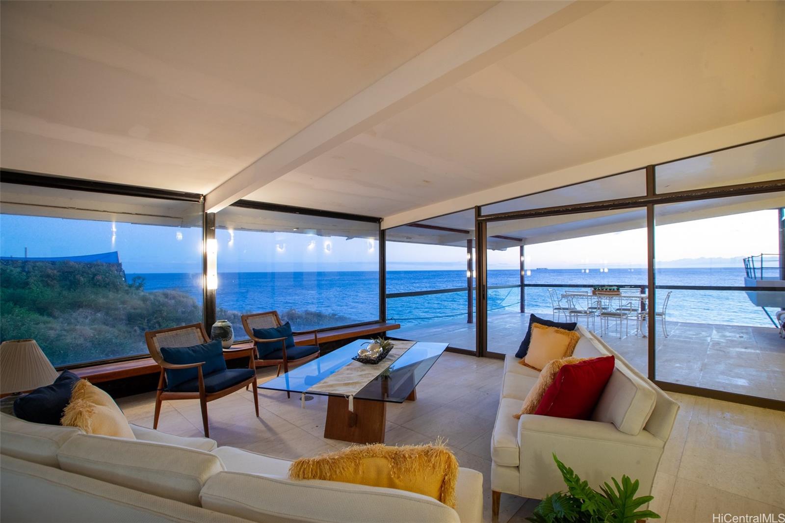 a living room with furniture and a floor to ceiling window