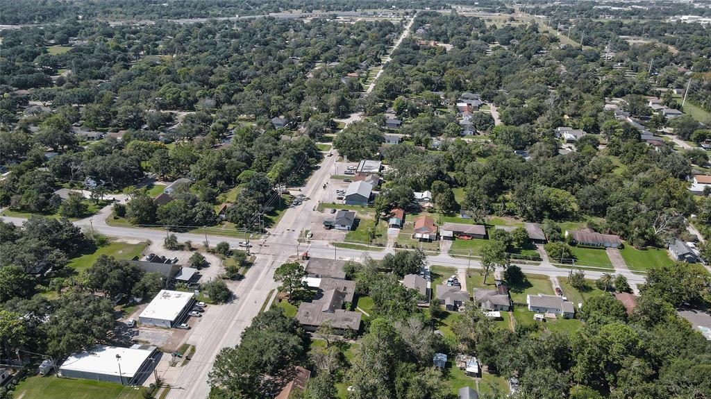 an aerial view of residential house with green space and trees all around