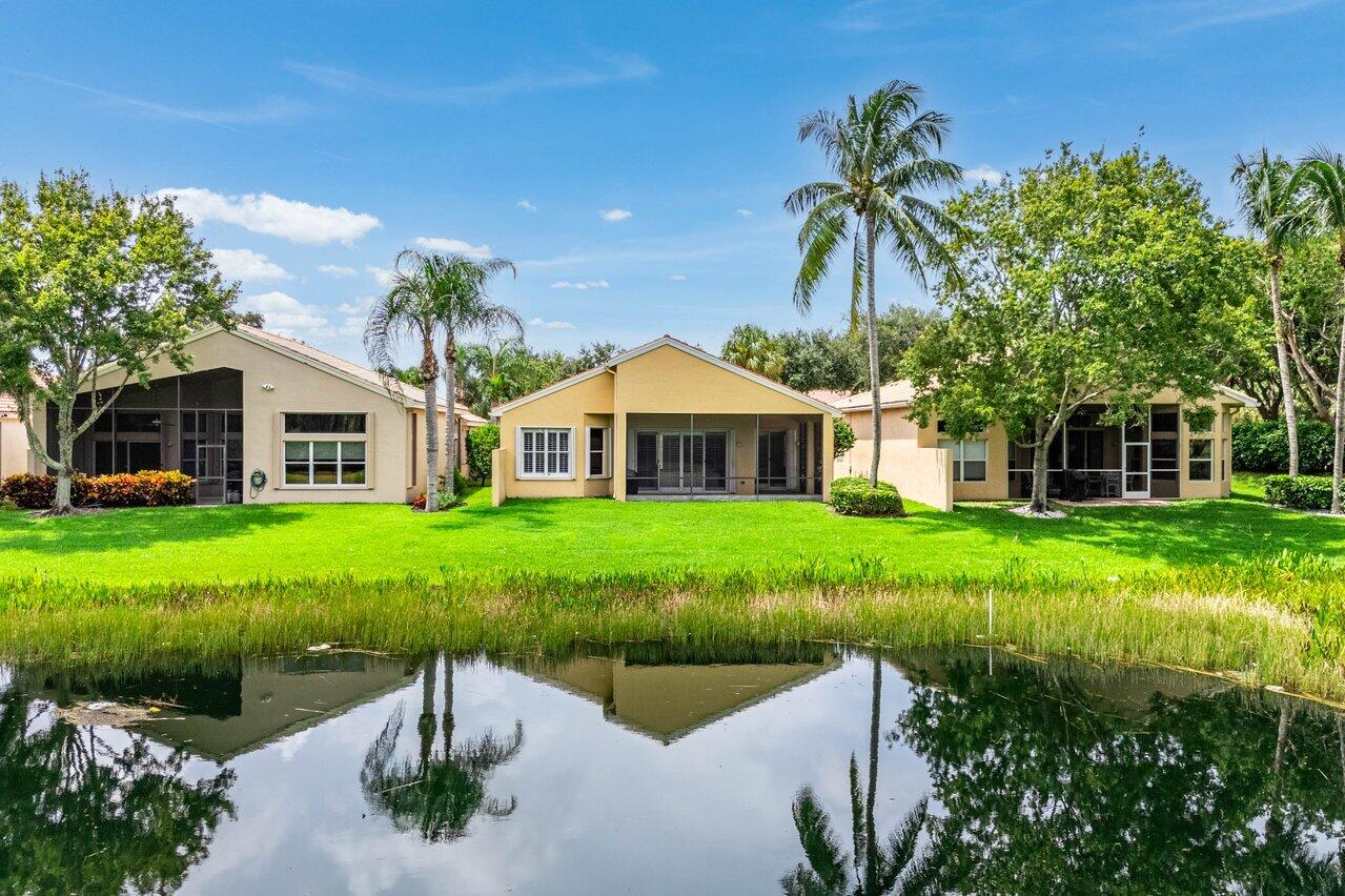 a front view of a house with yard and green space