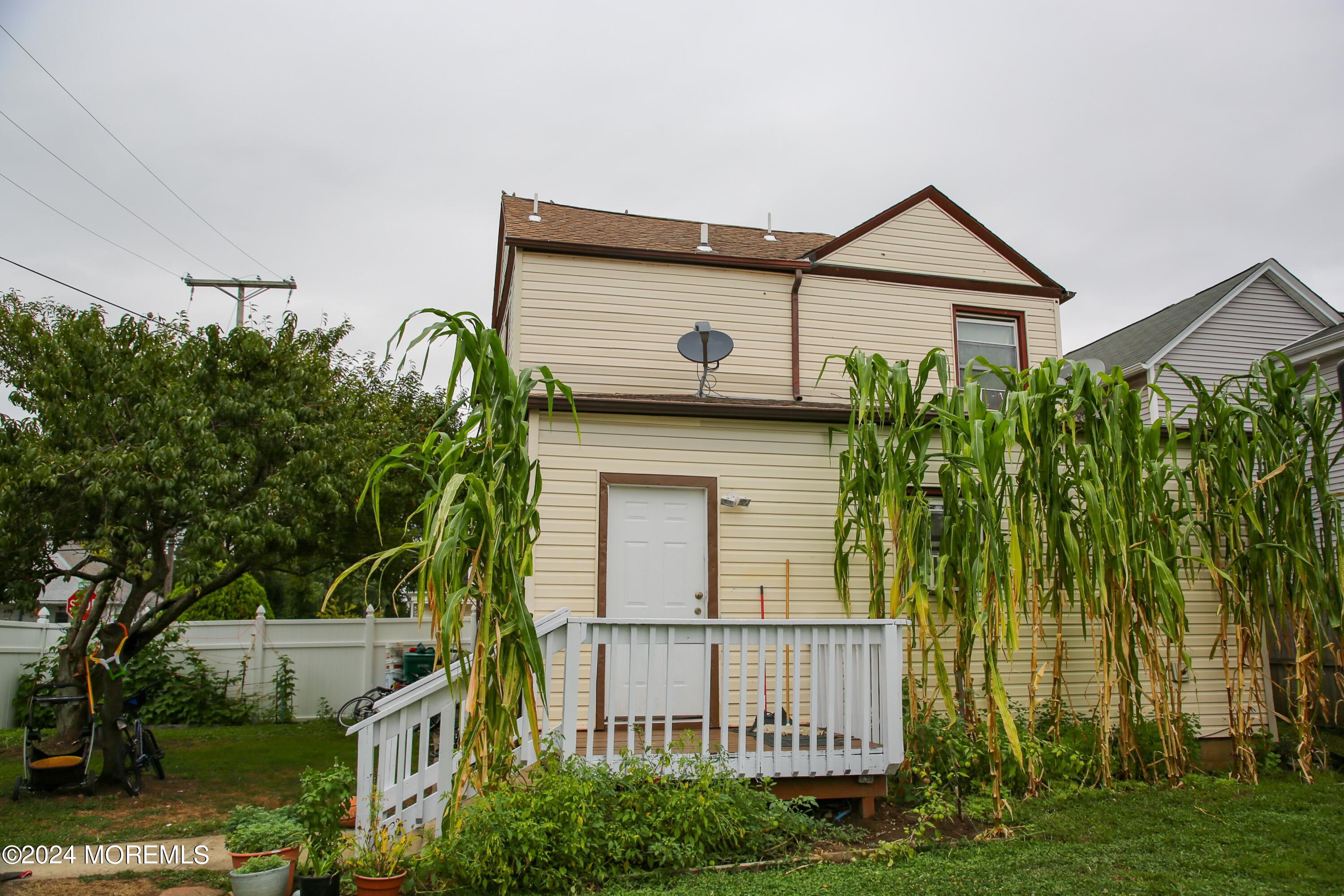 a front view of a house with a garden and plants