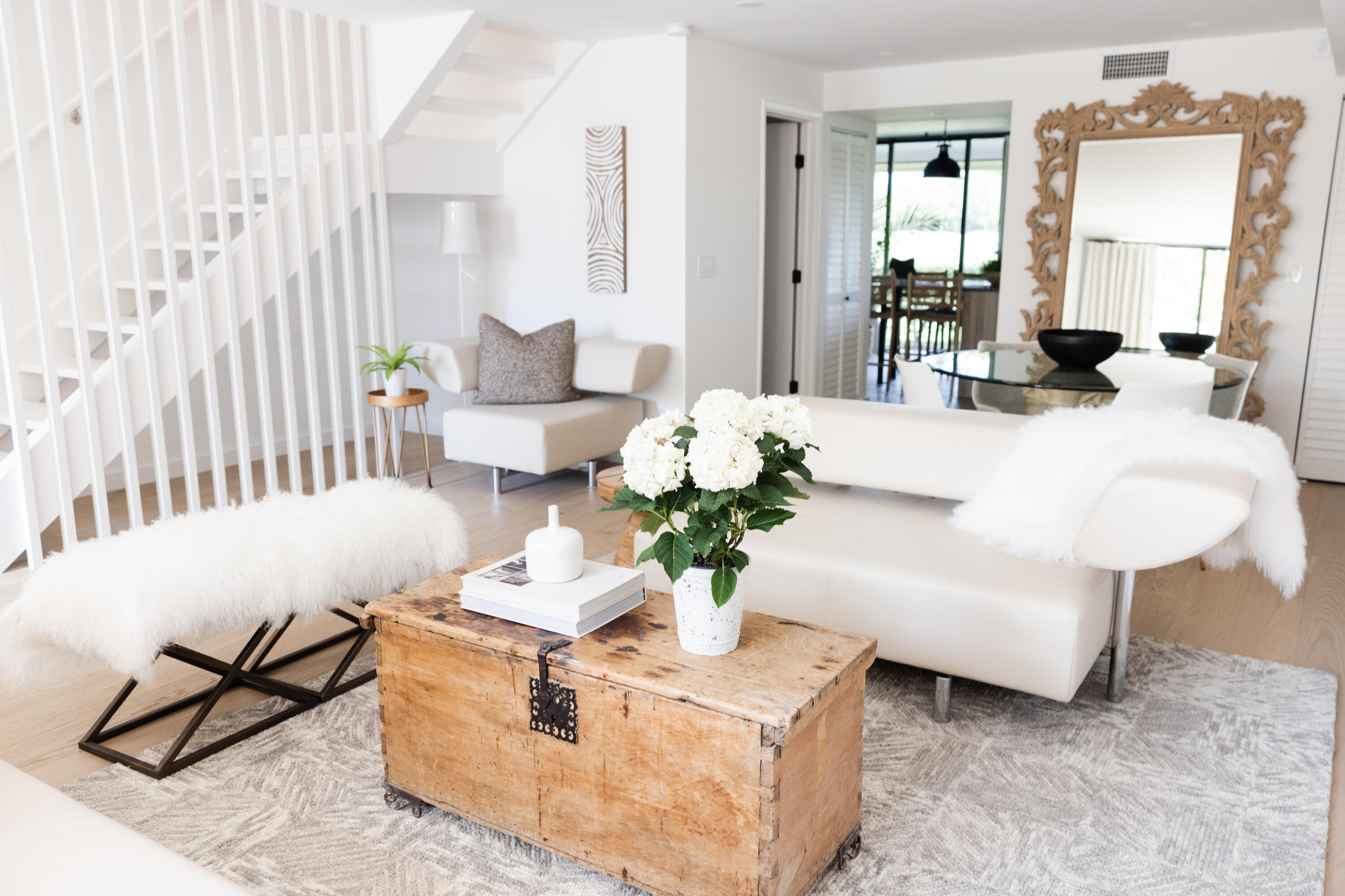 a living room with furniture potted plant and a window