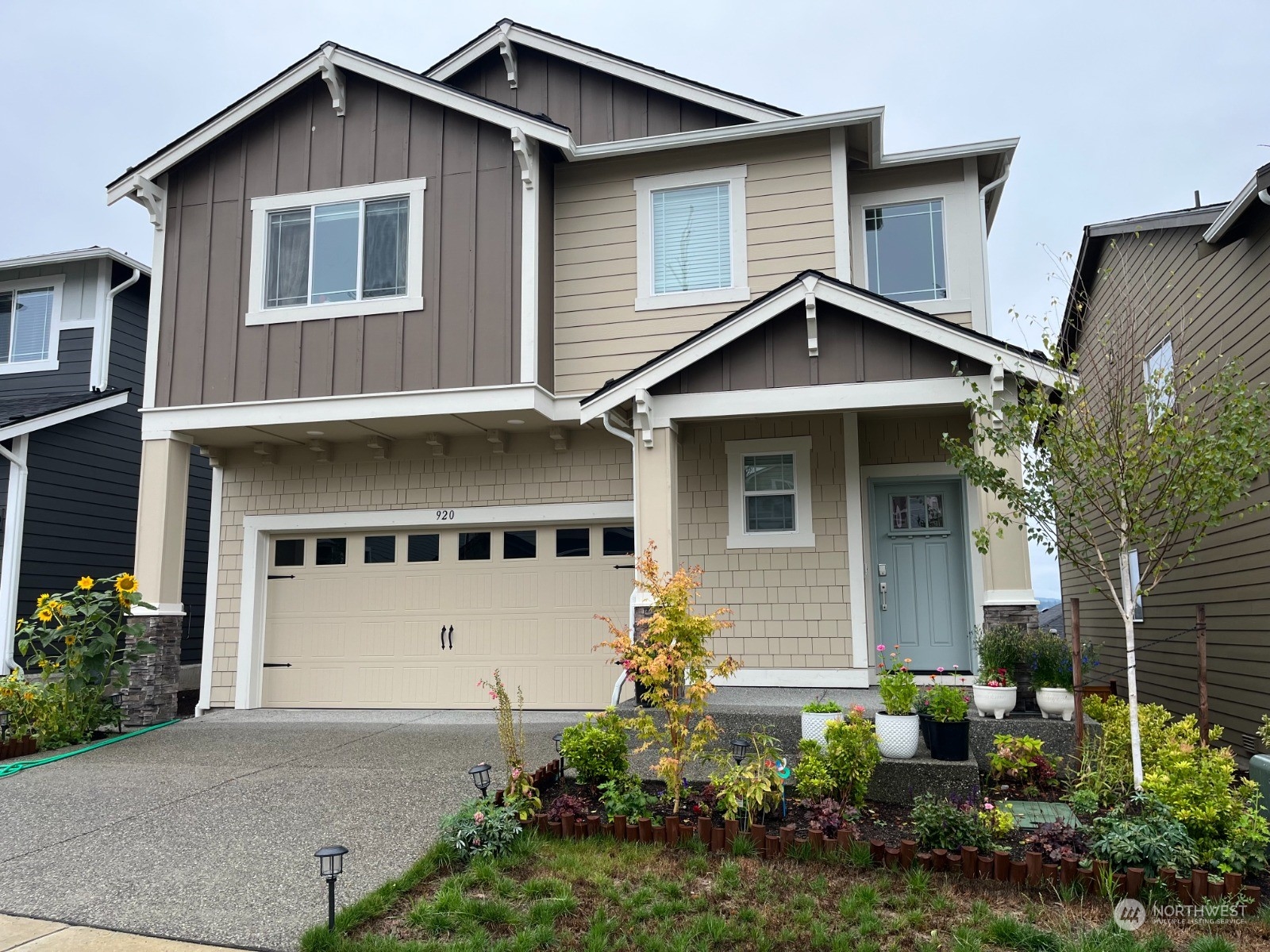 a front view of a house with a yard and garage