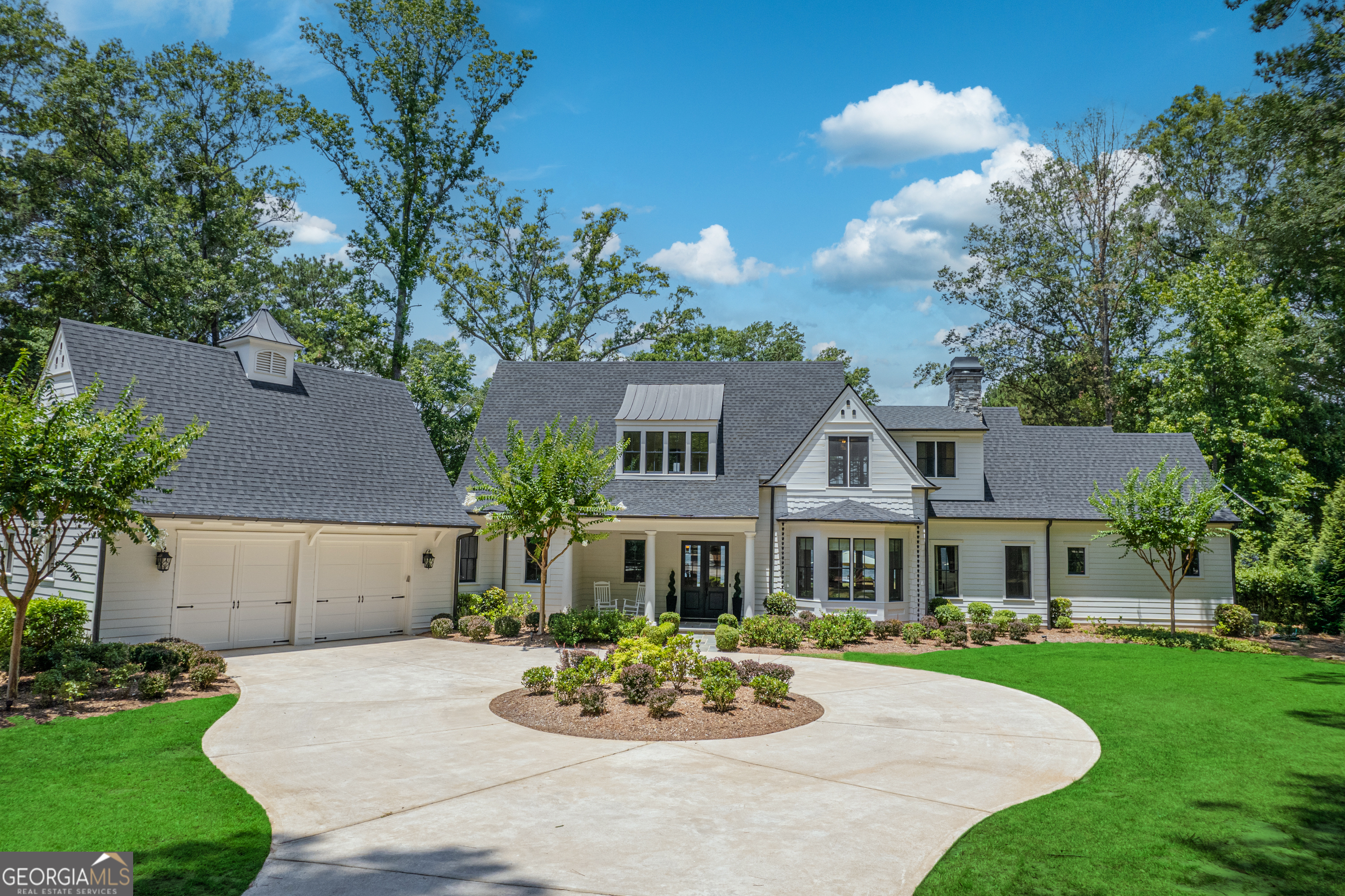 a front view of a house with a garden and patio