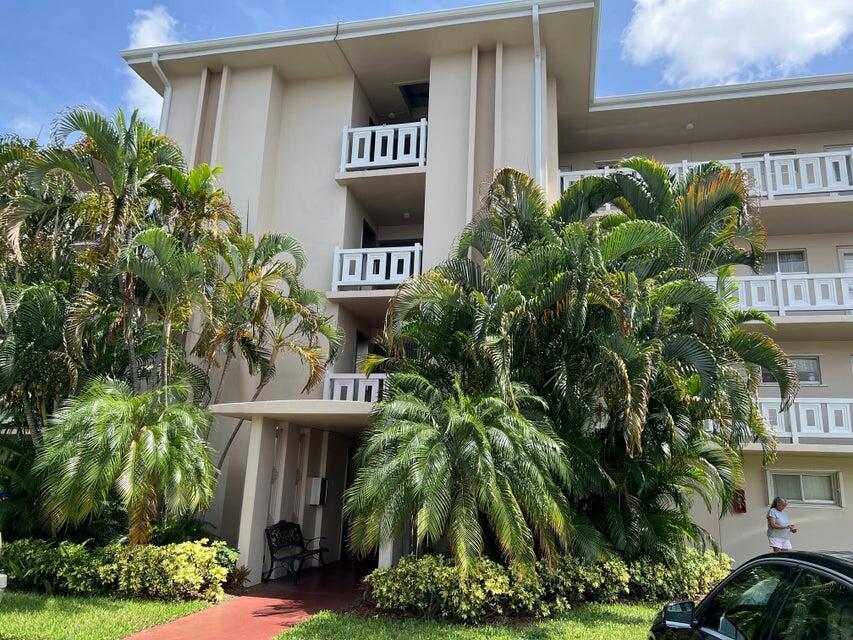 a front view of a house with plants