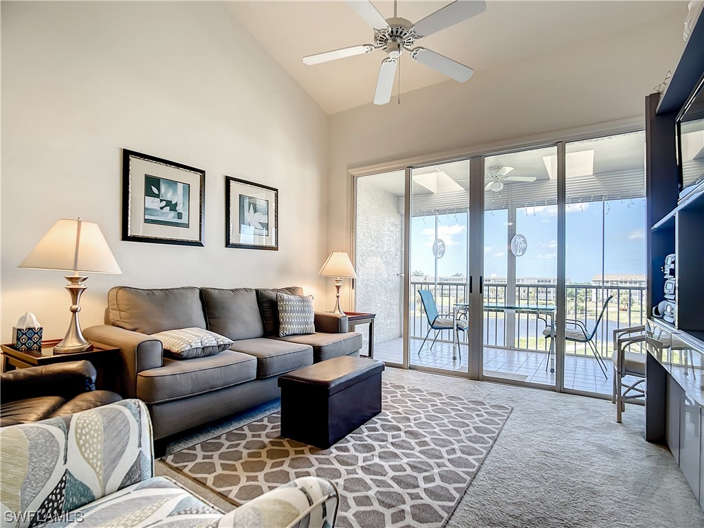 a living room with furniture and a floor to ceiling window