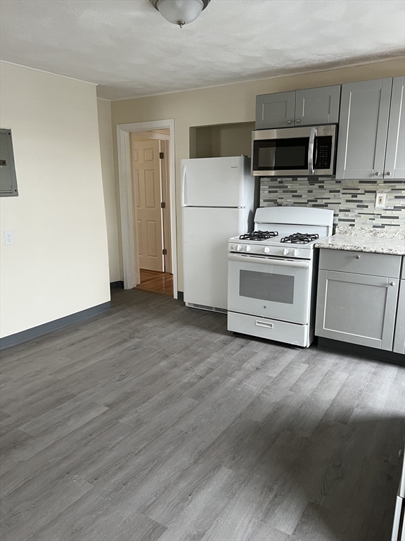 a kitchen with a refrigerator stove and a sink