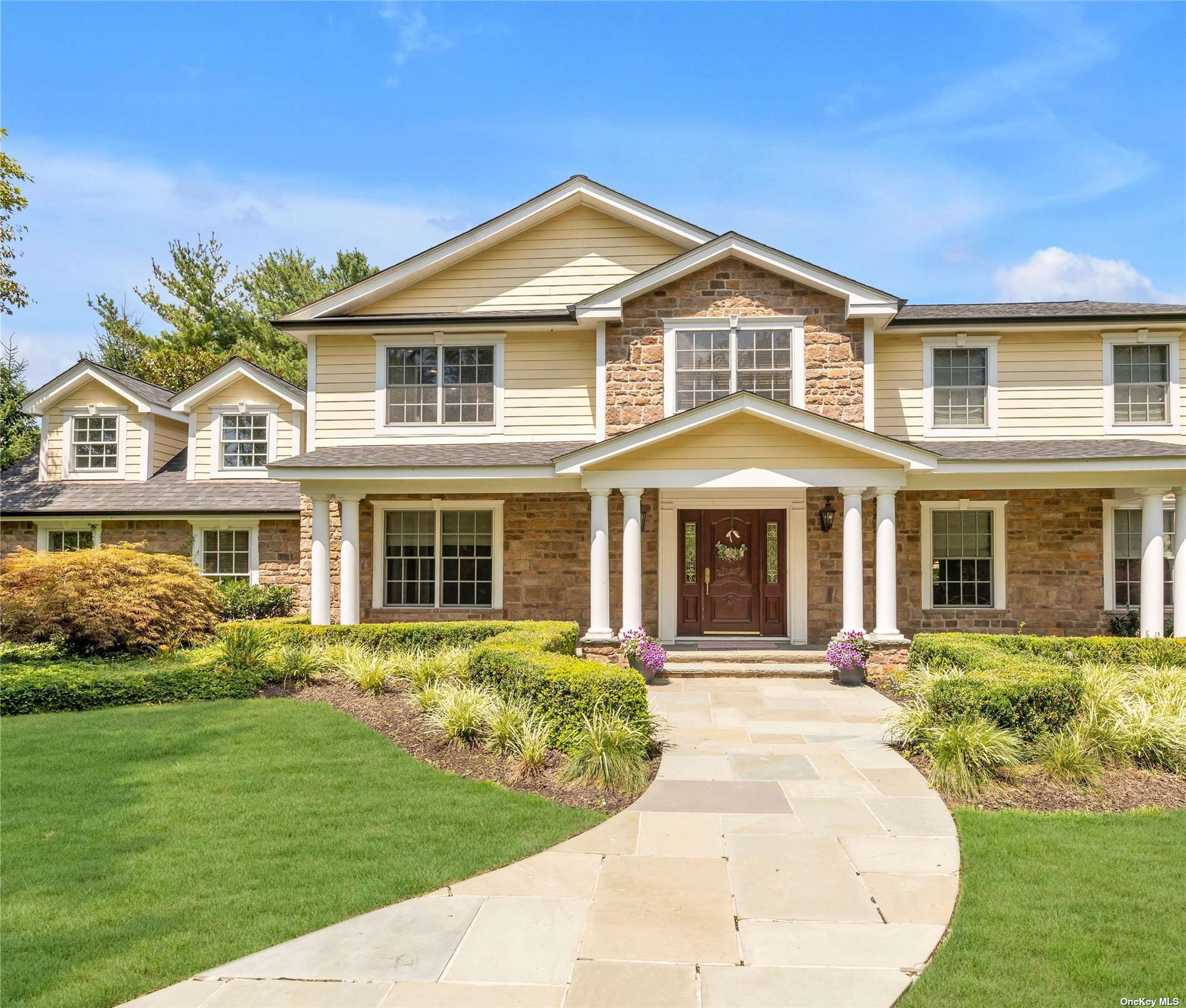 a front view of a house with garden