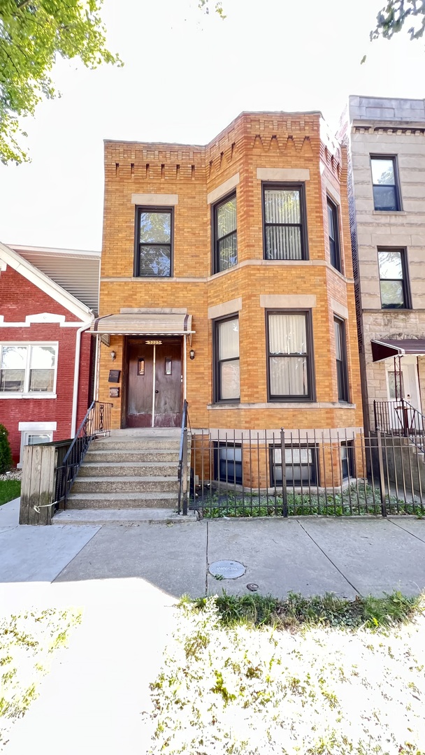 a front view of a residential apartment building with a yard