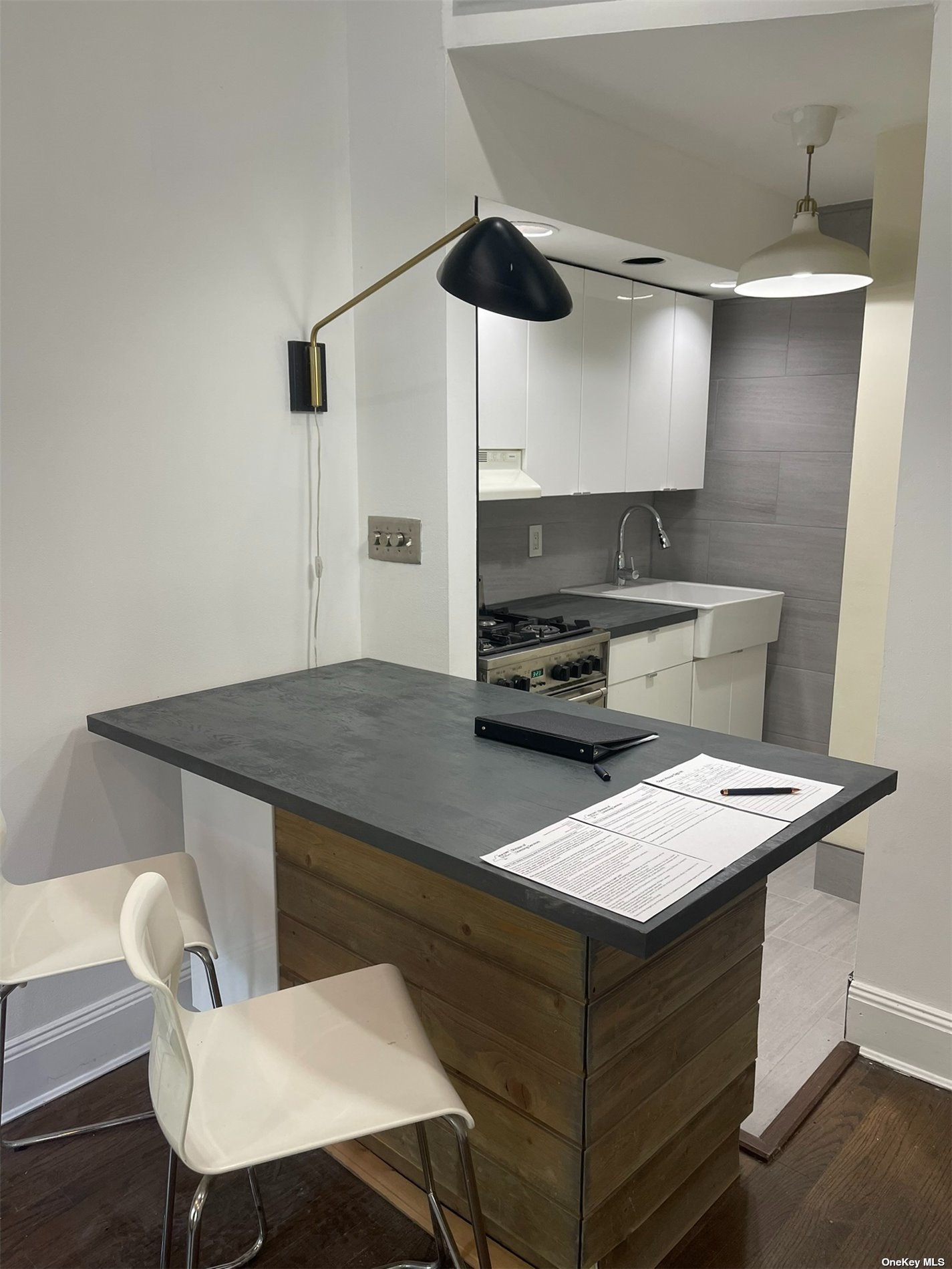 a kitchen with a table chairs and white cabinets