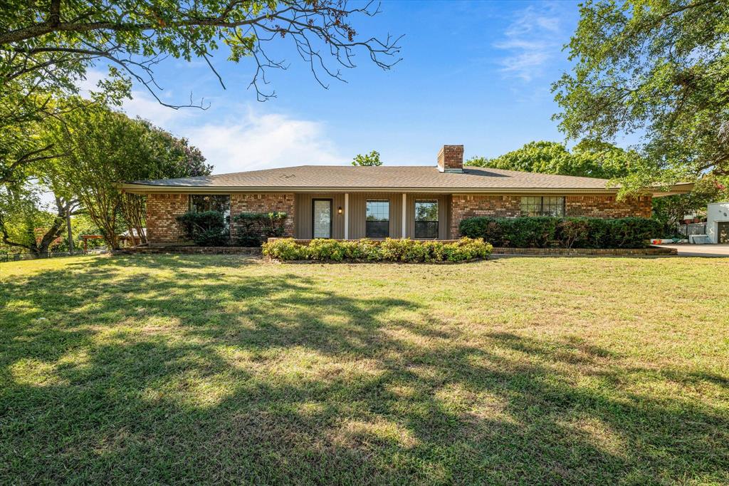 a front view of house with yard and green space