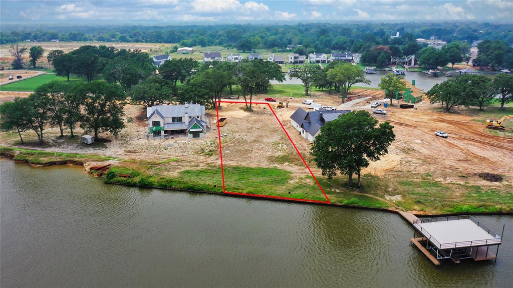 an aerial view of a house with a garden and lake view