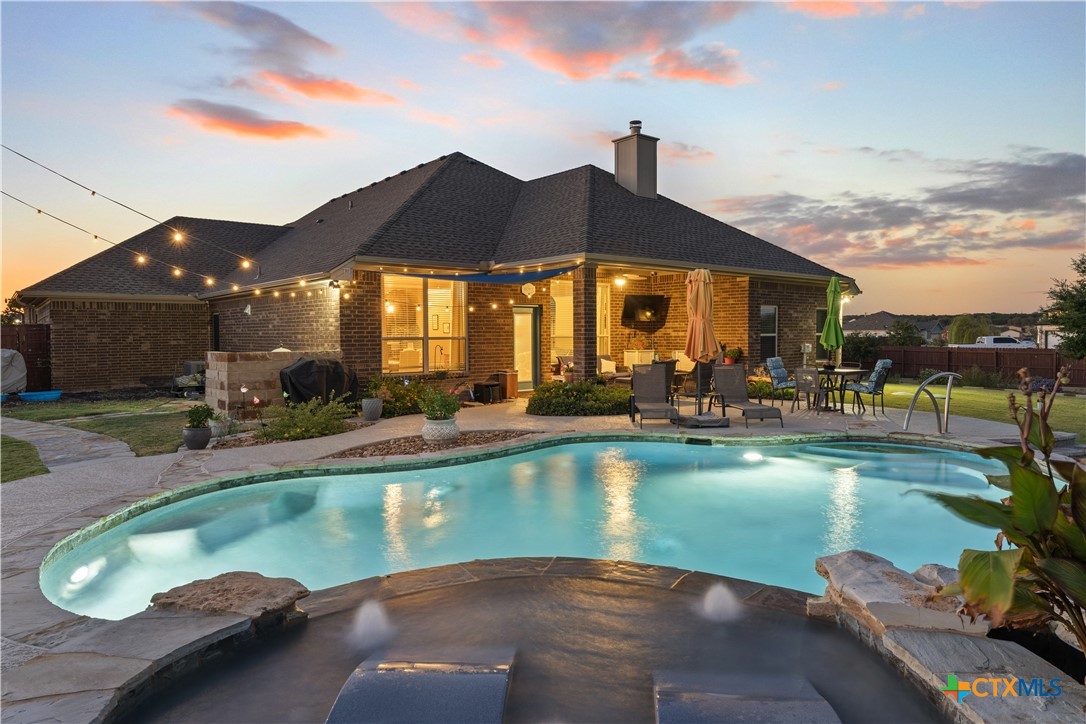 a view of a swimming pool with a patio