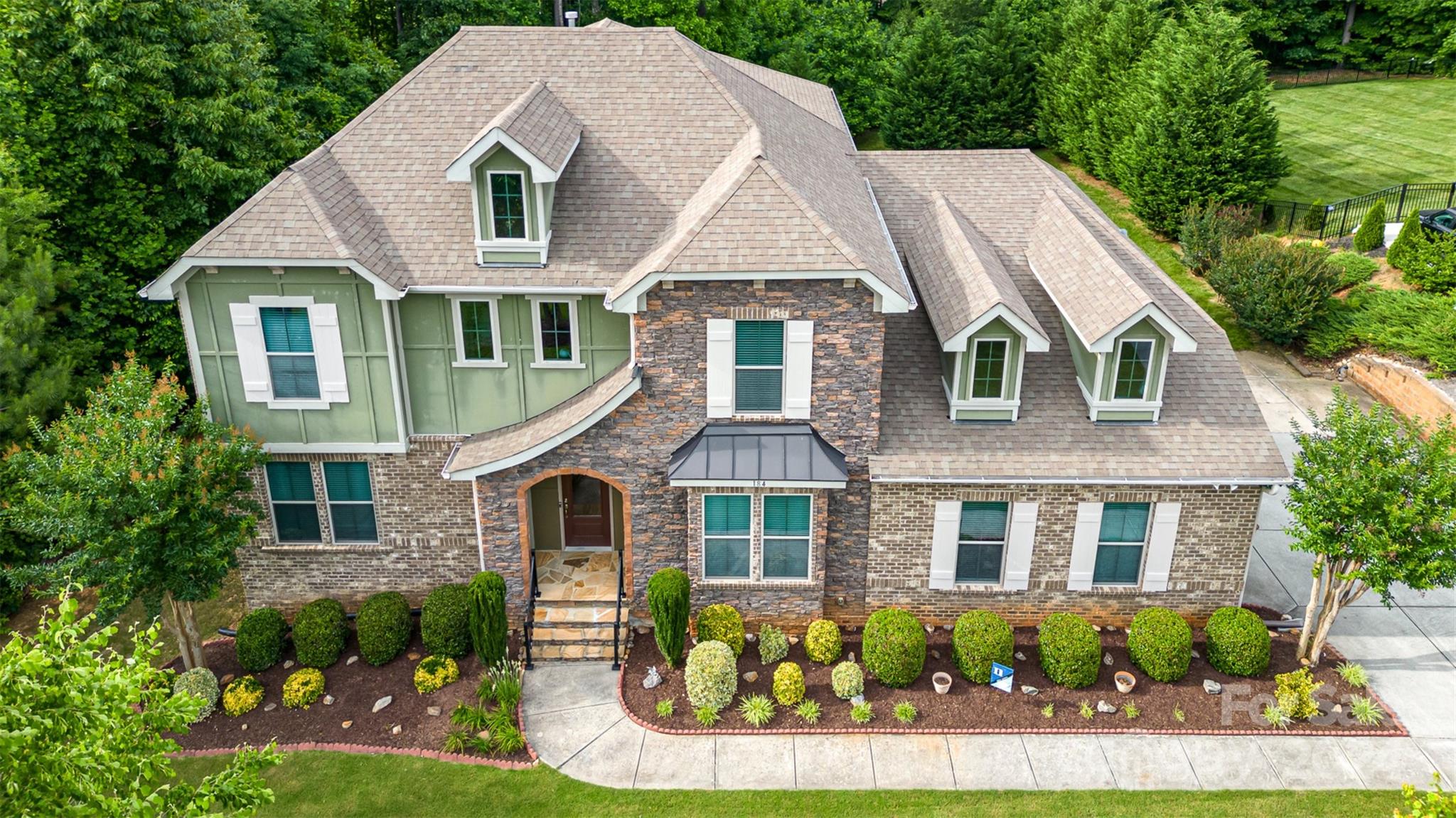 a front view of a house with garden