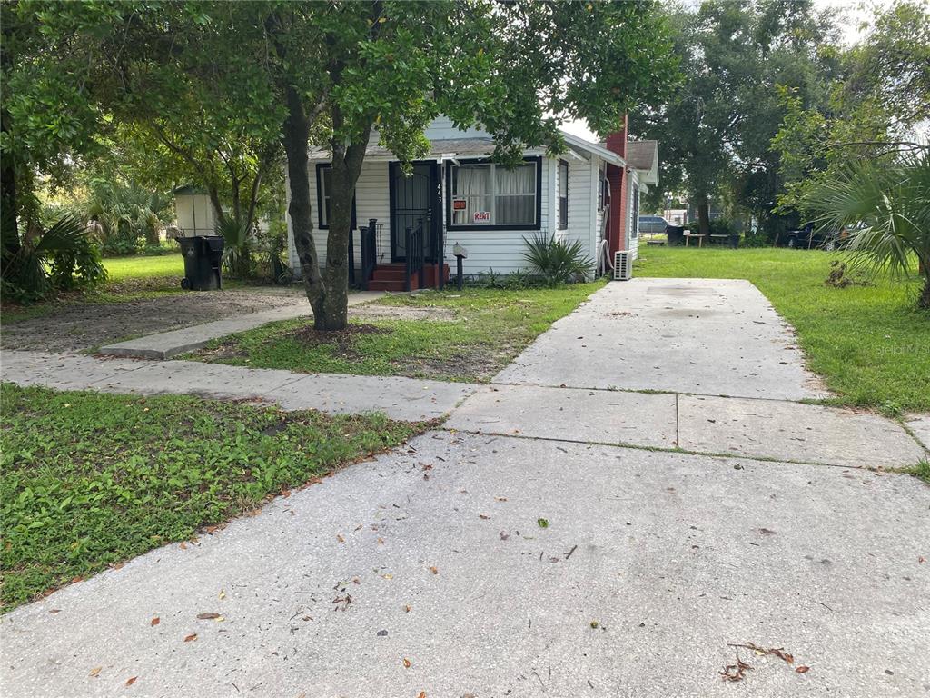 a view of a house with a yard and tree s