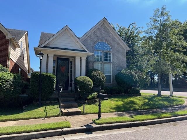 a front view of a house with garden