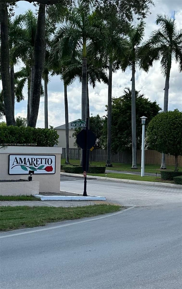 a view of street with sign board and yard