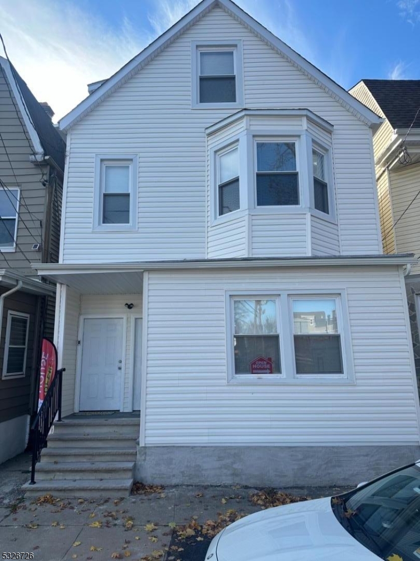 a front view of a house with stairs