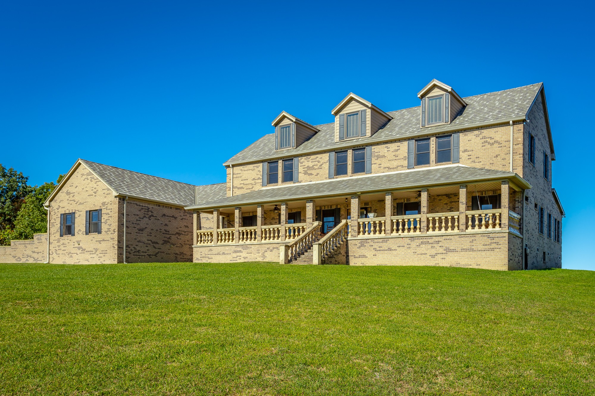 a front view of a house with a garden and yard