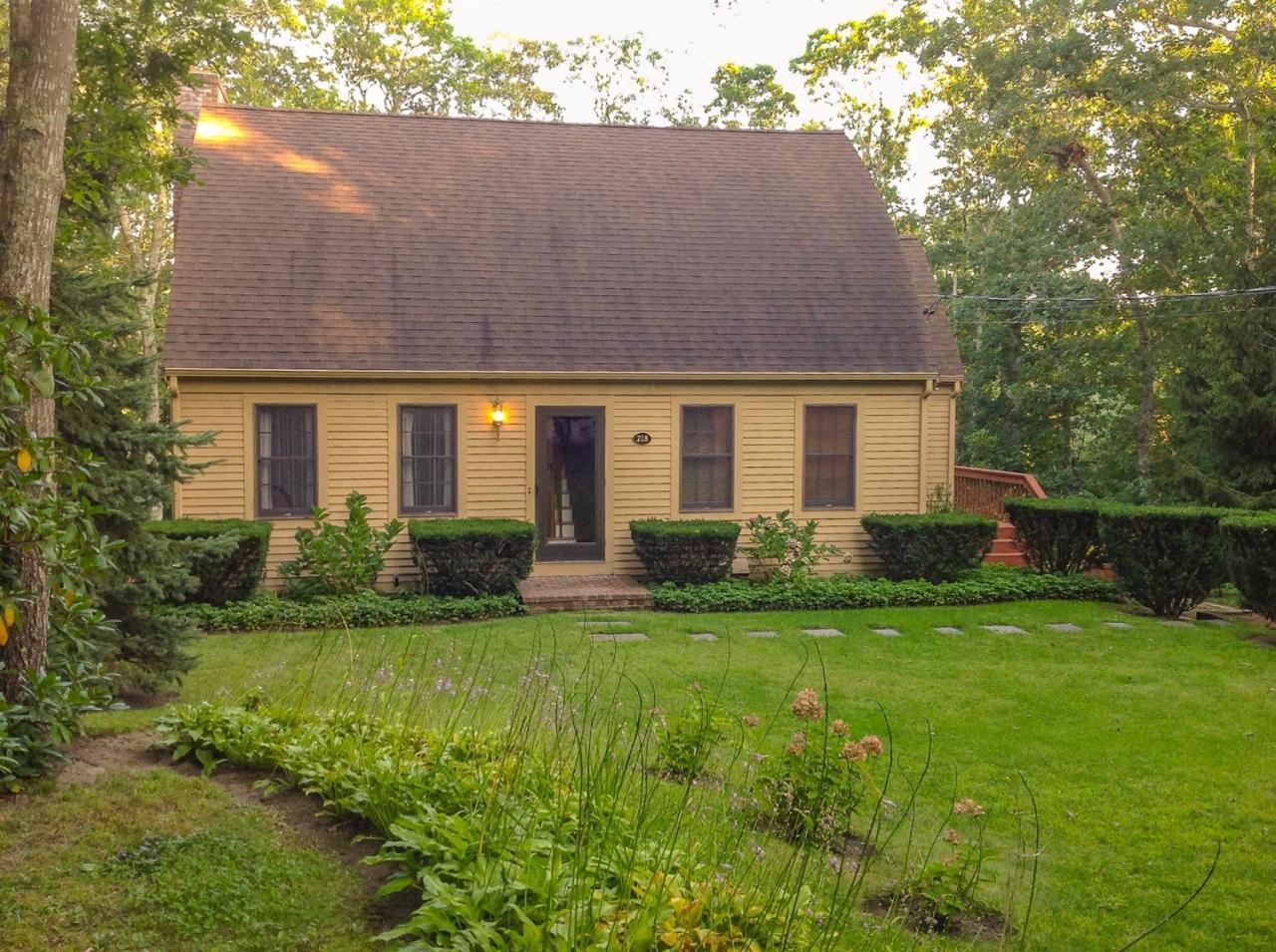 a front view of house with yard and green space