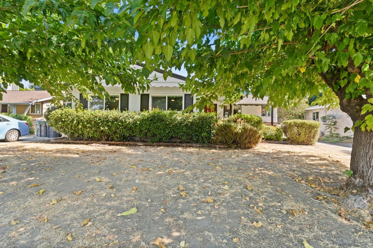 a front view of a house with a garden