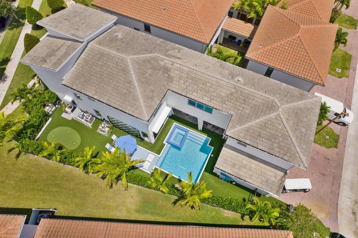 an aerial view of a house with garden space and street view