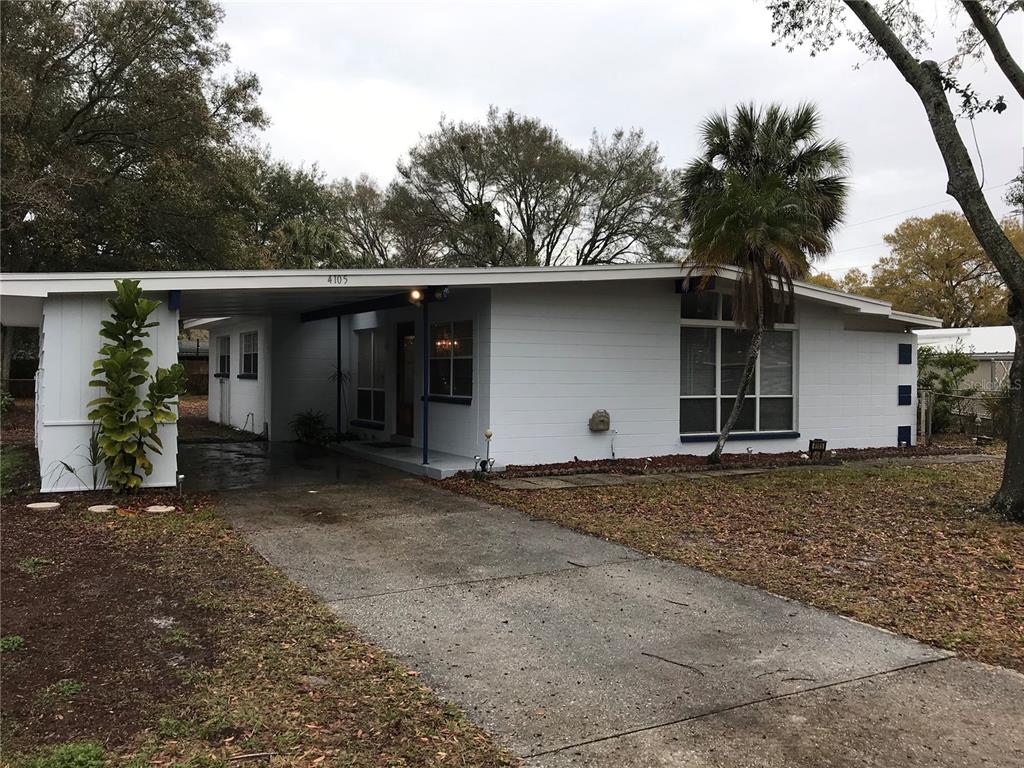 a view of a house with a yard and garage