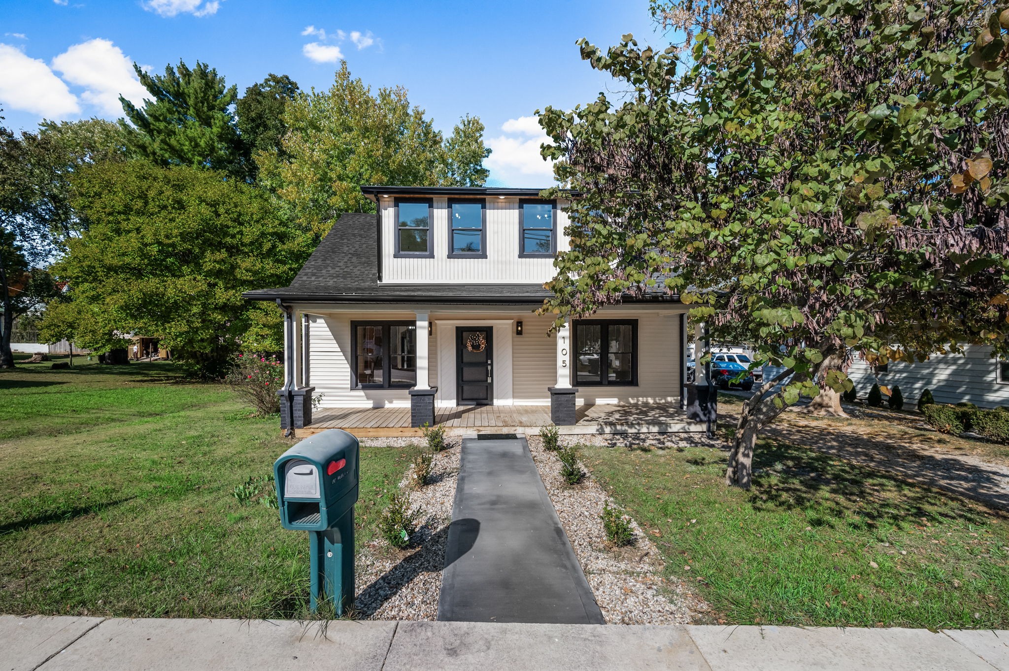 a front view of house with yard and green space