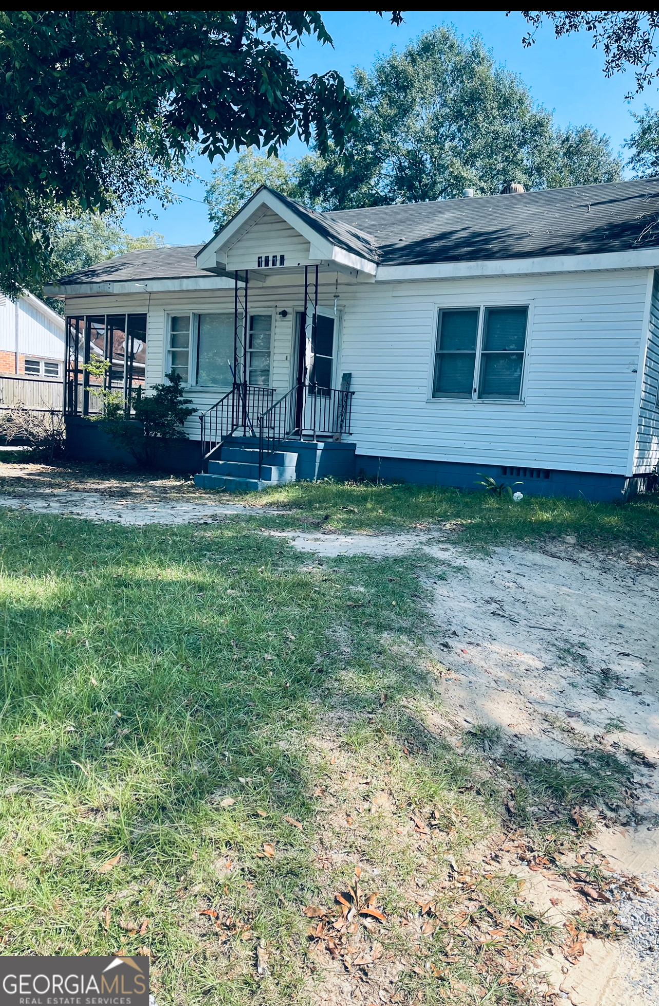 a view of a house with a yard and sitting area