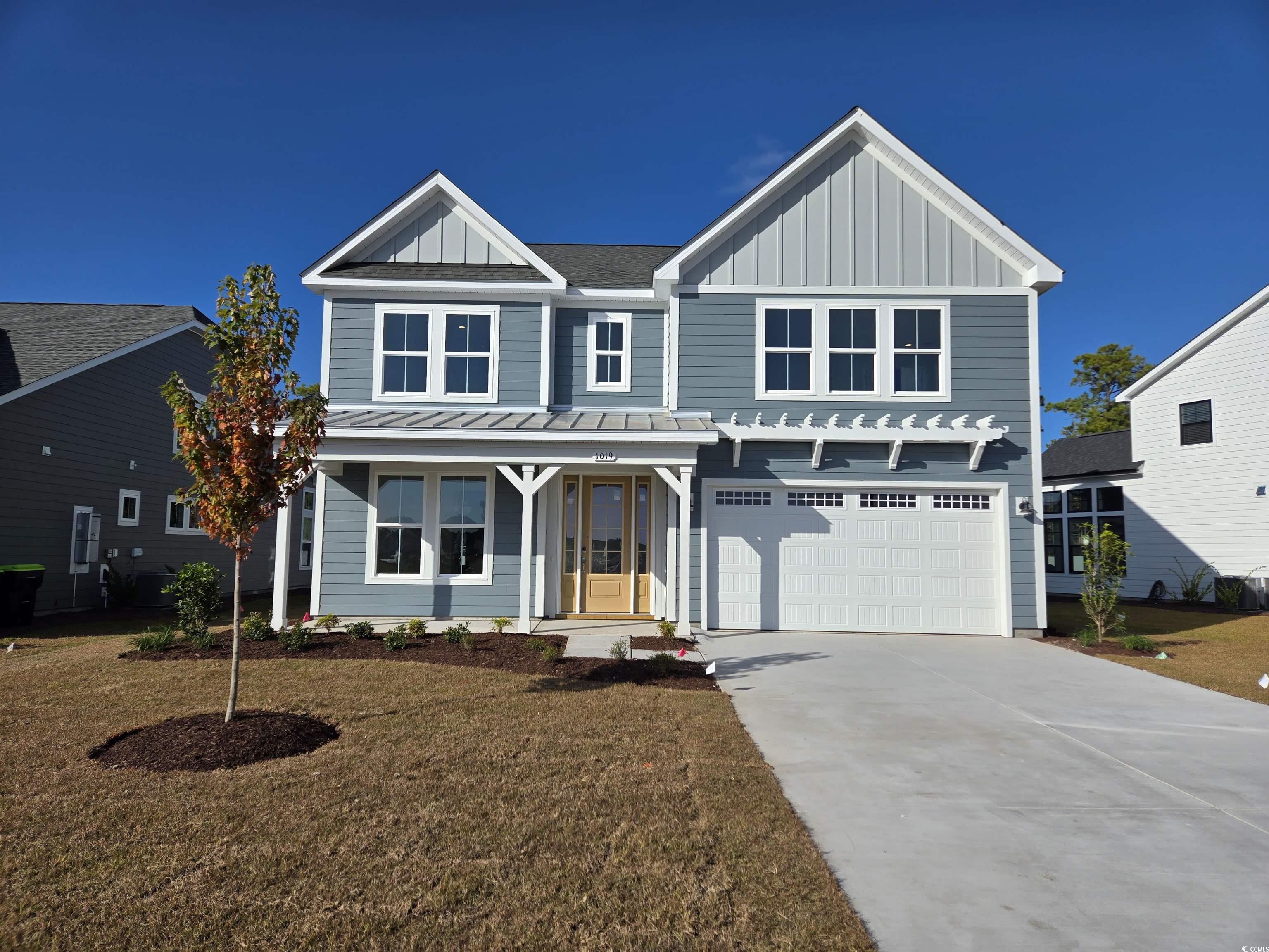 View of front of property with a porch, a front ya