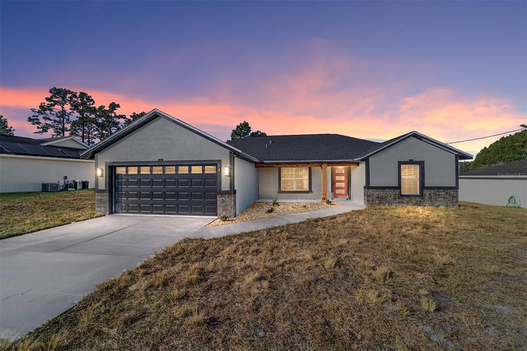 a front view of a house with a yard and garage