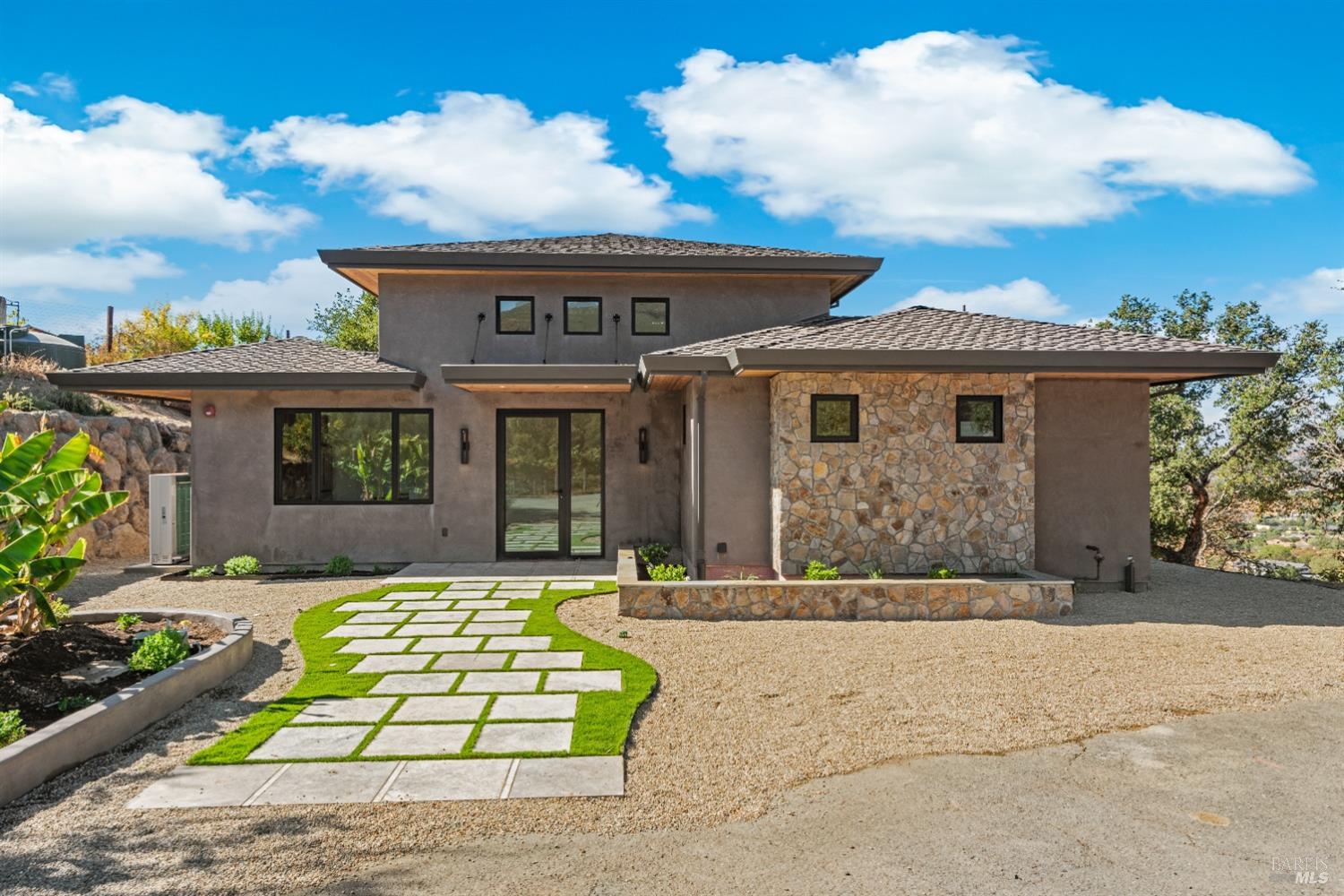 a front view of a house with garden