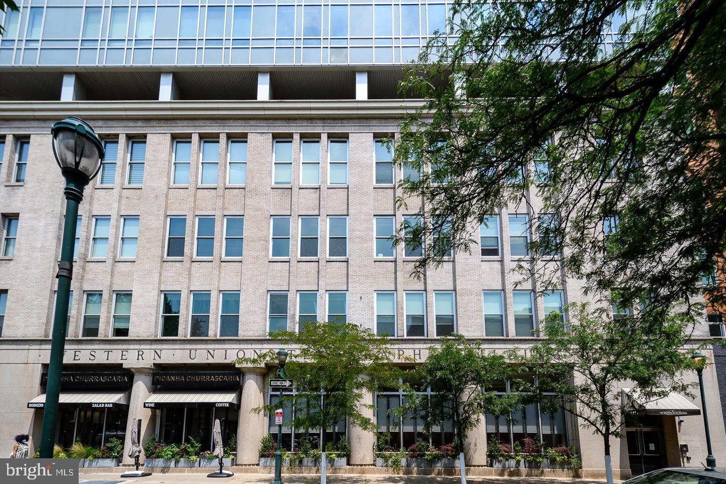 a front view of a building with glass windows and entryway