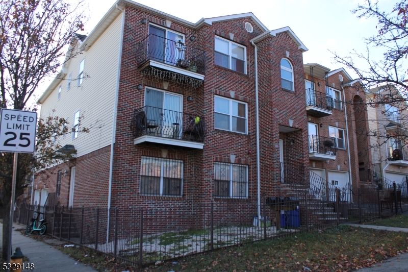 a view of a brick building next to a yard