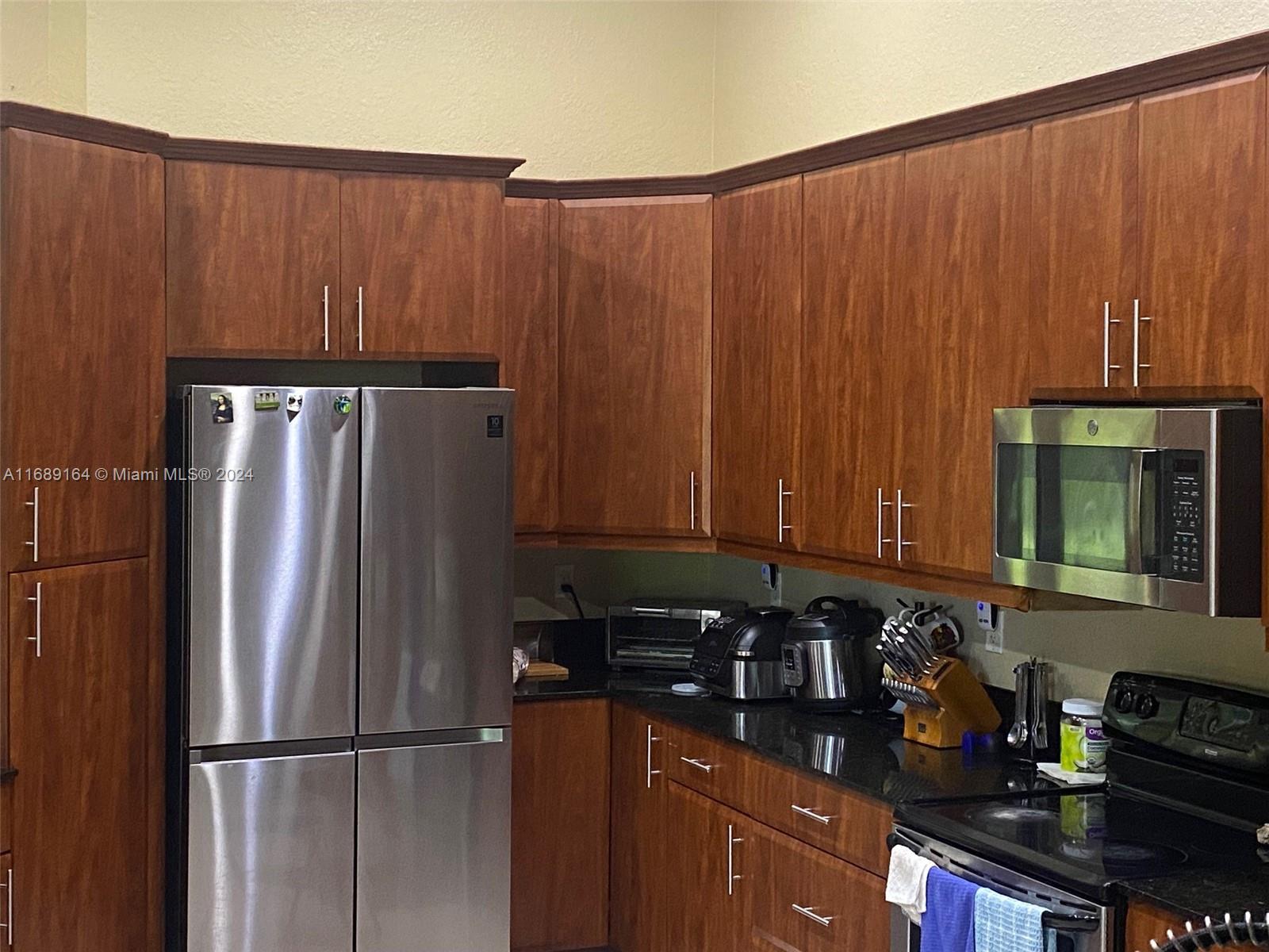 a kitchen with appliances and cabinets