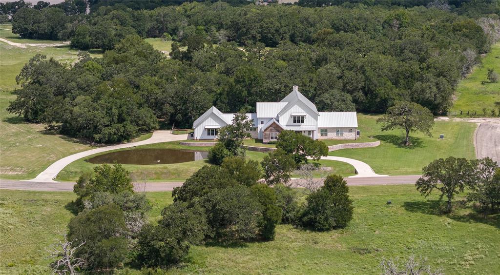 a view of a house with a swimming pool and a yard