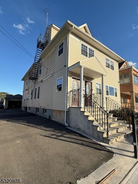 a front view of a house with stairs