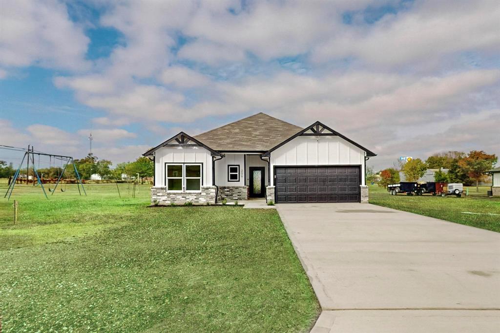 a front view of house with yard and green space