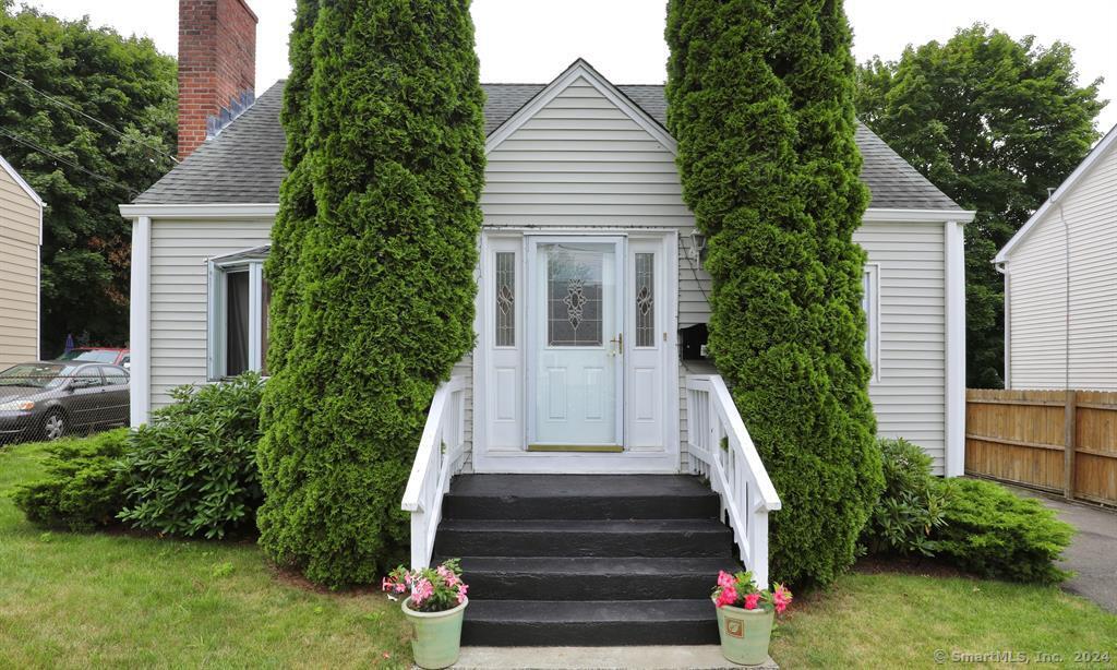 a view of house with outdoor space and trees