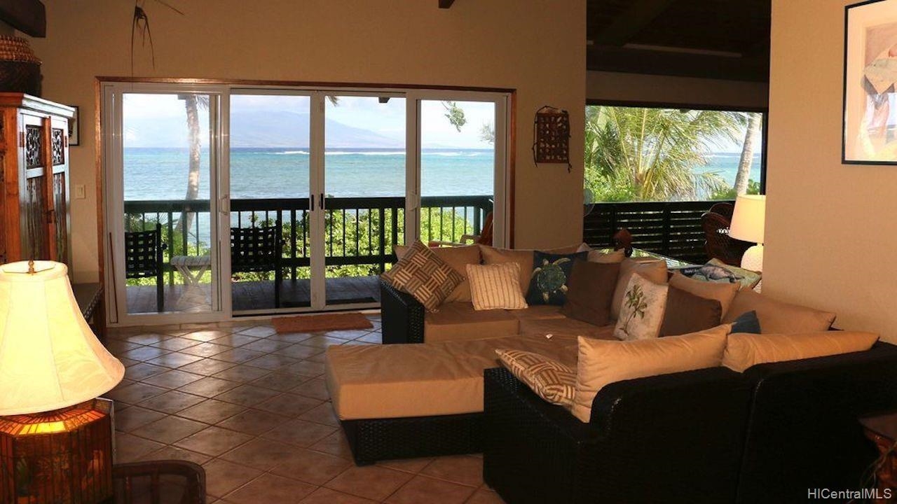 a living room with furniture tv and large window