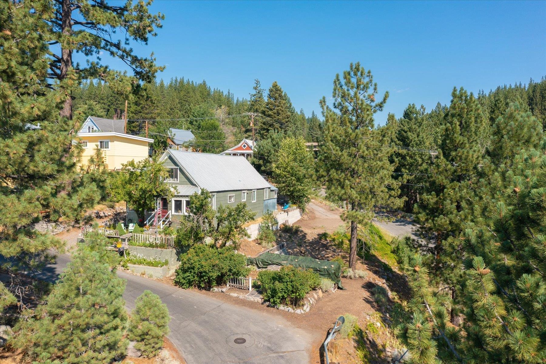 an aerial view of a house with yard and outdoor seating