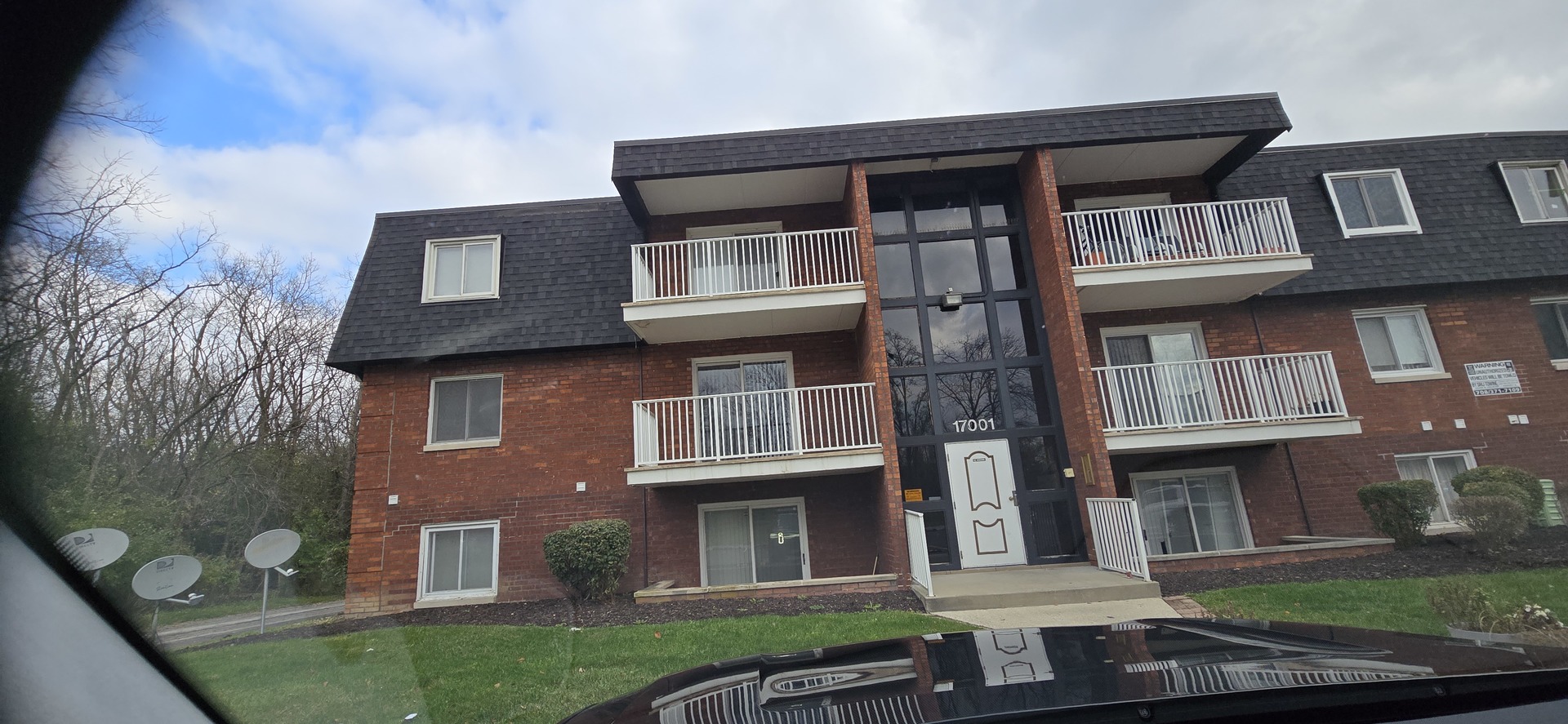 a front view of a residential apartment building with a yard