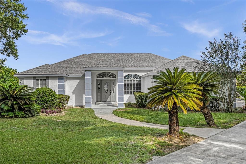 a front view of house with yard and green space