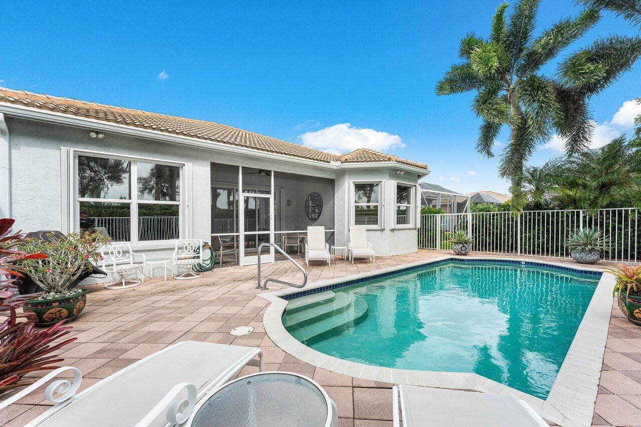 a swimming pool with outdoor seating yard and barbeque oven