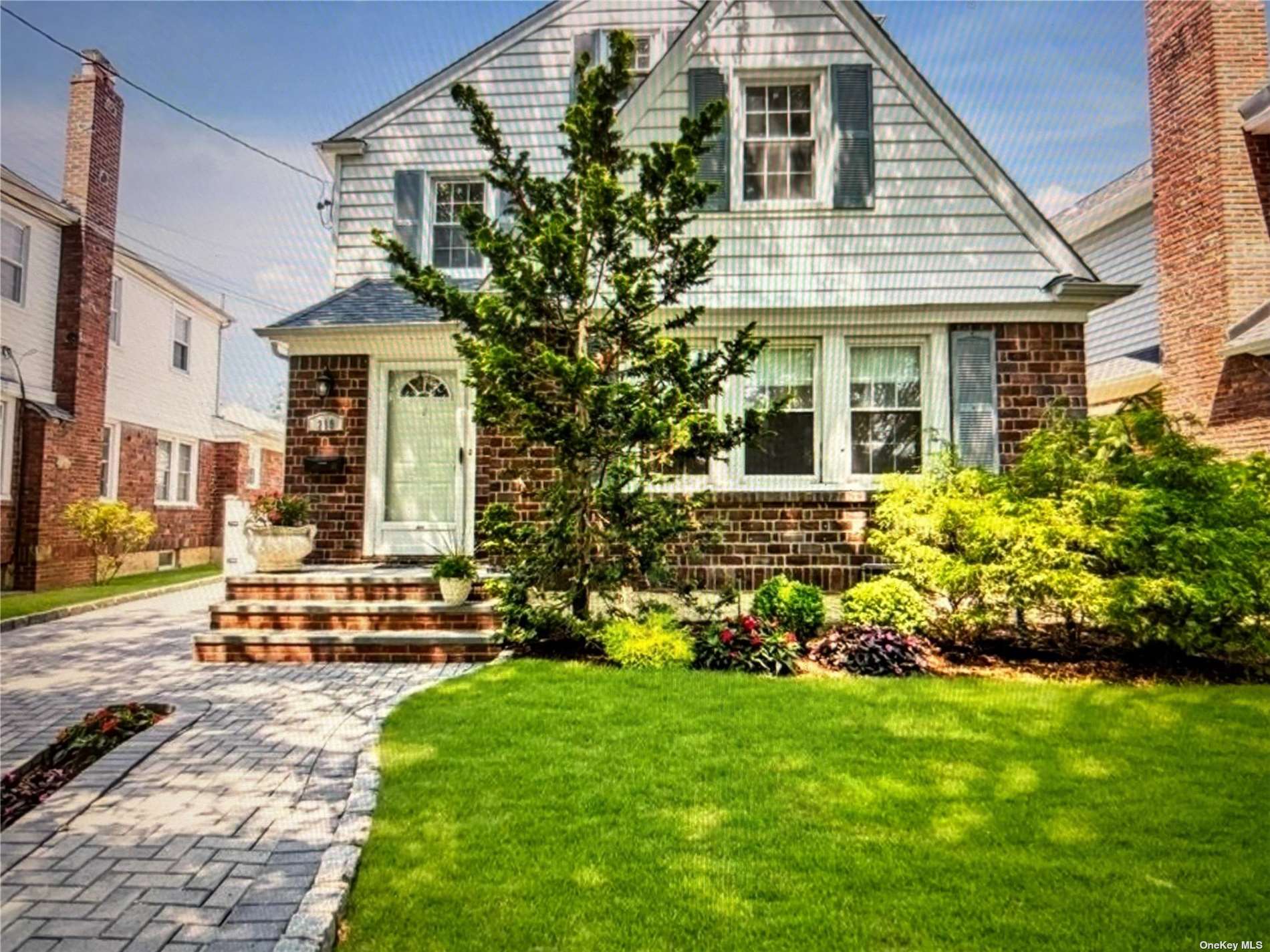 a front view of a house with a garden