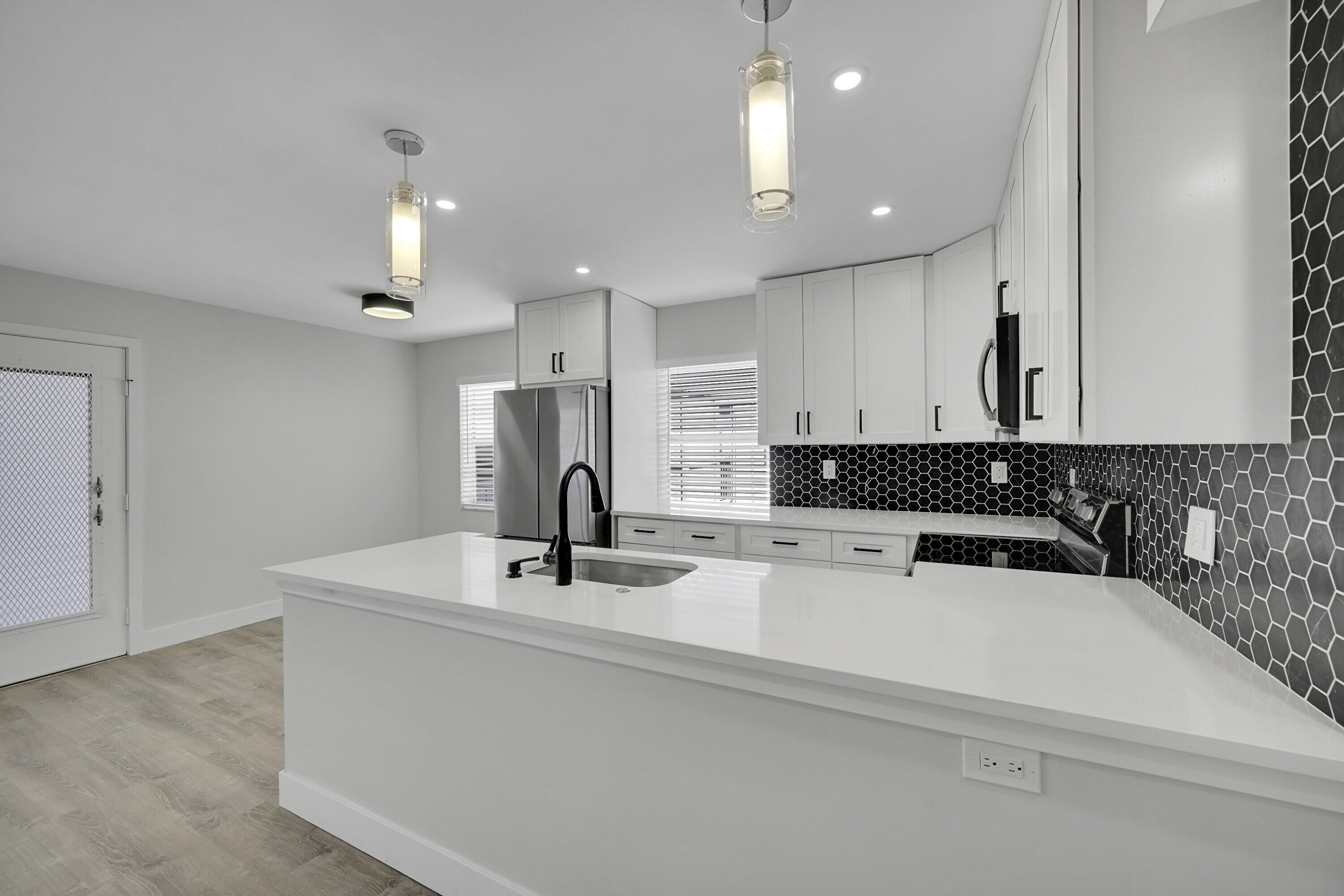 a kitchen with a sink a stove and refrigerator