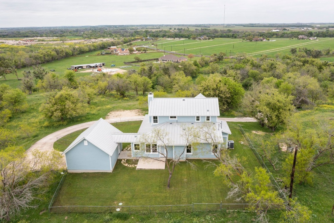 an aerial view of residential houses with outdoor space and river