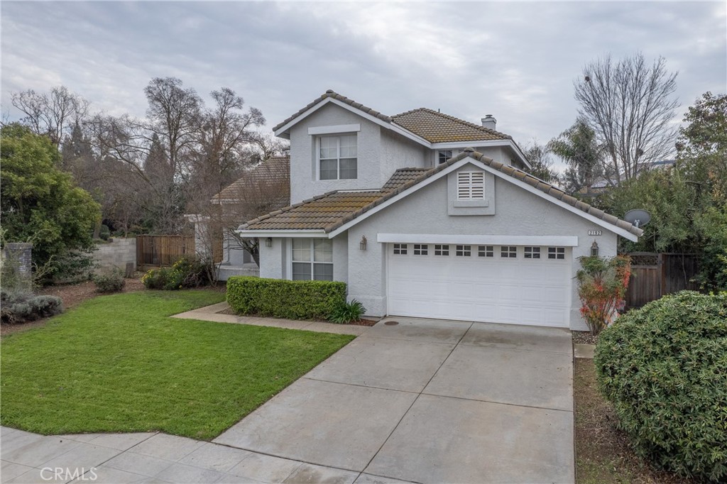 a view of a house with yard and tree s